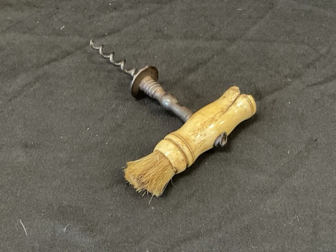 A Georgian Henshall type corkscrew with turned bone brush handle