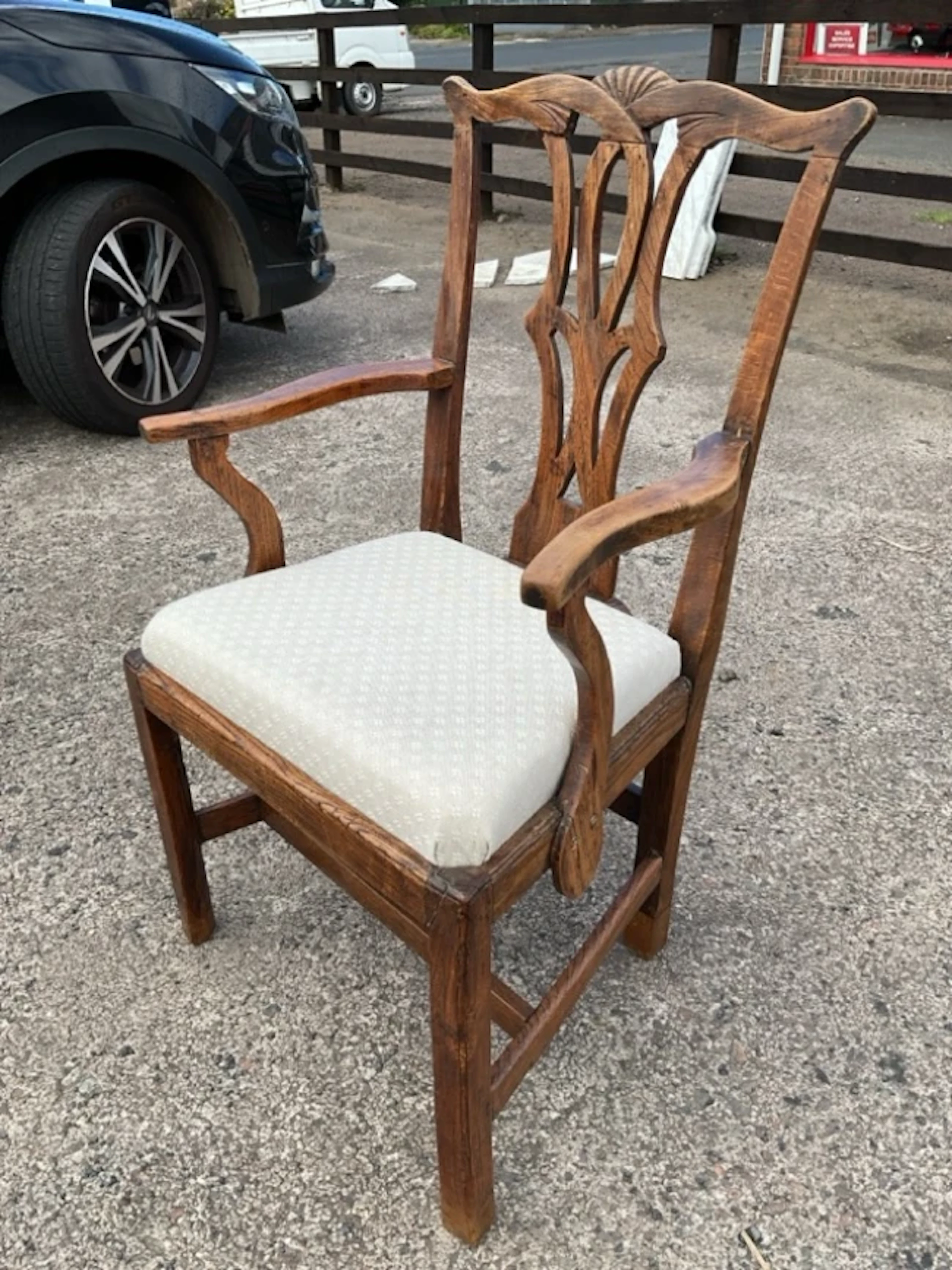 A Georgian elm country Chippendale armchair with shell carved wavy
