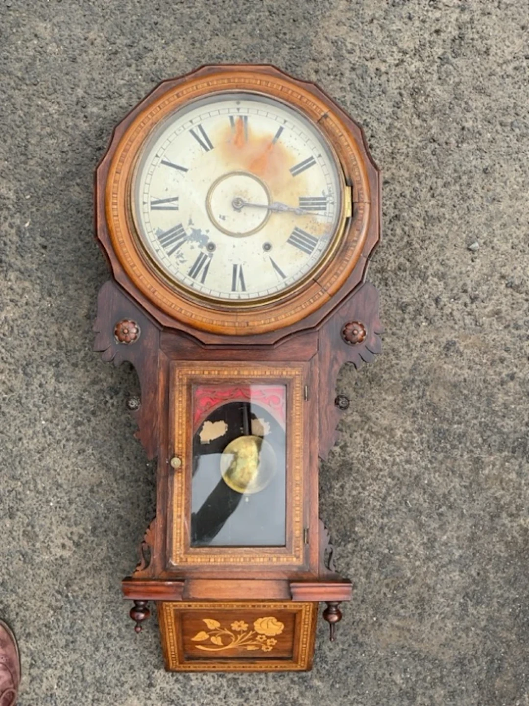 A Victorian wallclock with circular dial having roman chapters and