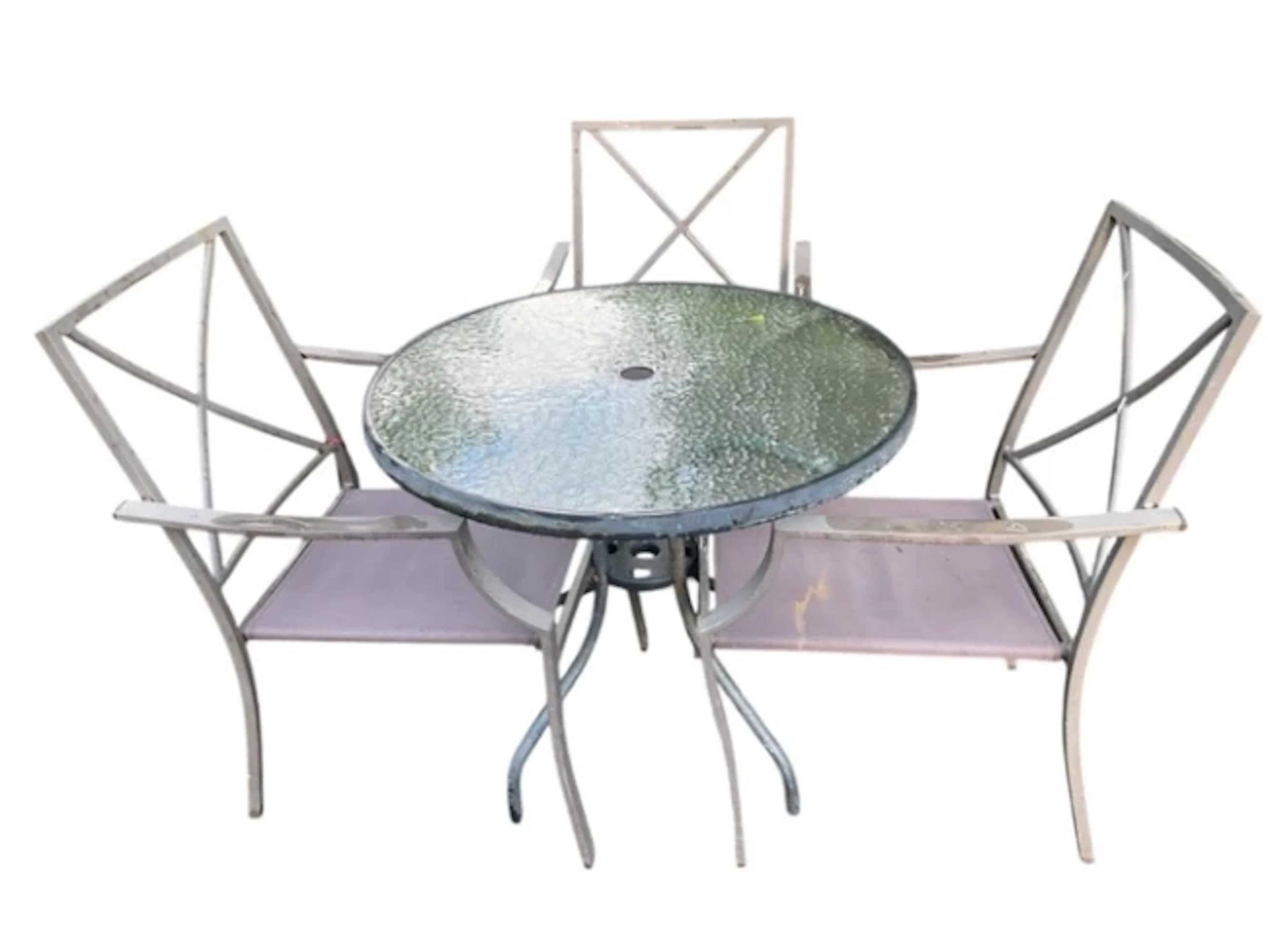 A circular glass topped garden table on four tubular legs, with three