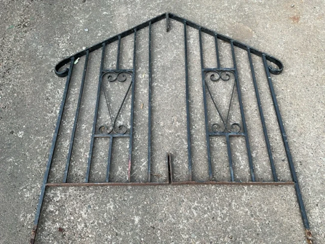 A pair of wrought iron rails for steps with square spindles supporting