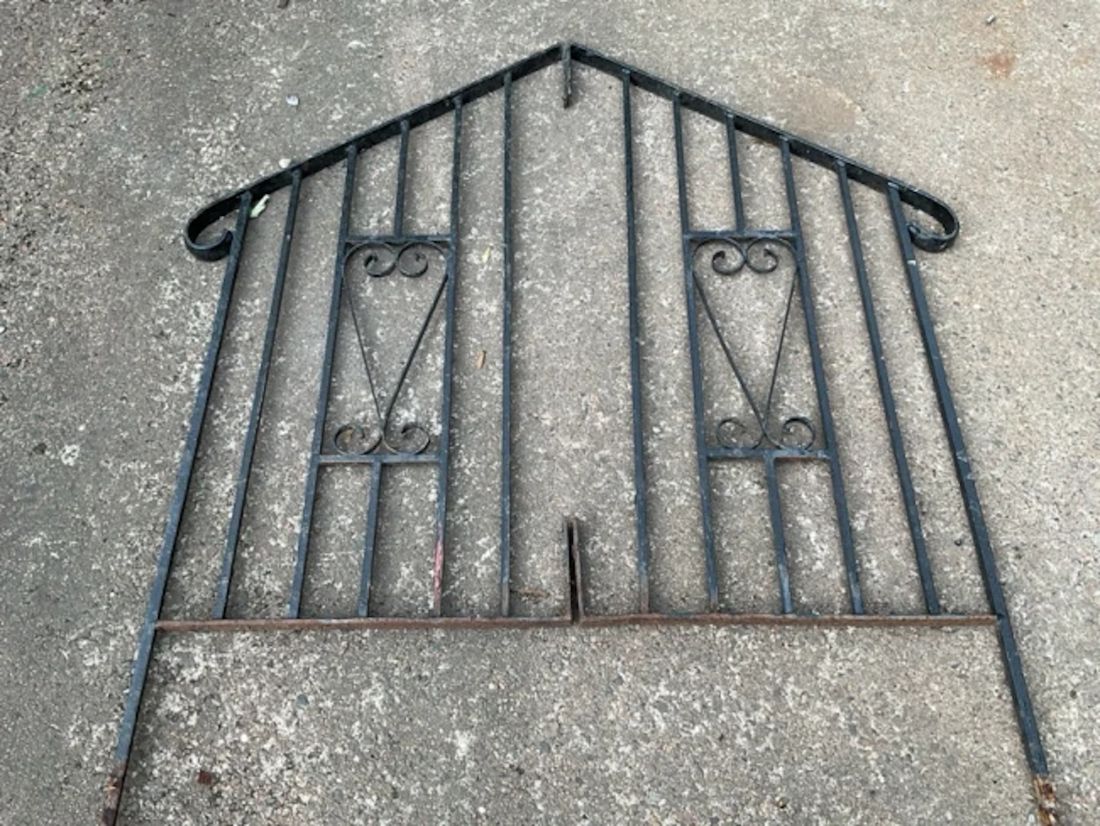 A pair of wrought iron rails for steps with square spindles supporting