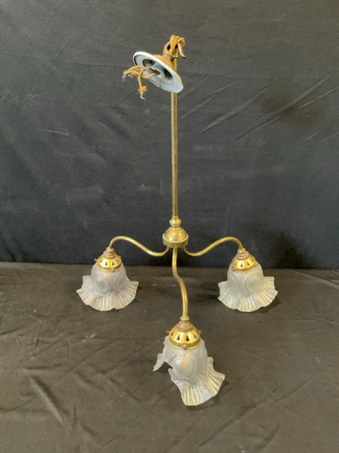 A Edwardian three-light brass chandelier with circular rose suspending