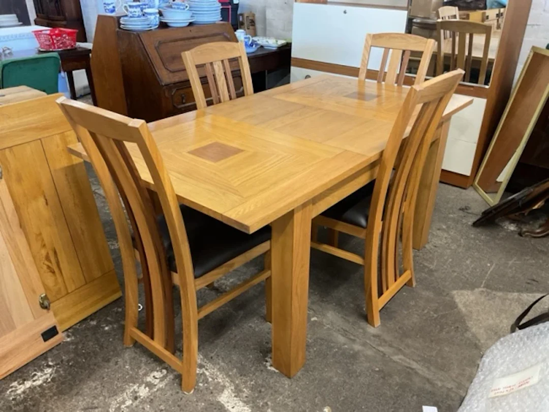 A contemporary oak dining table & chair set, the rectangular table