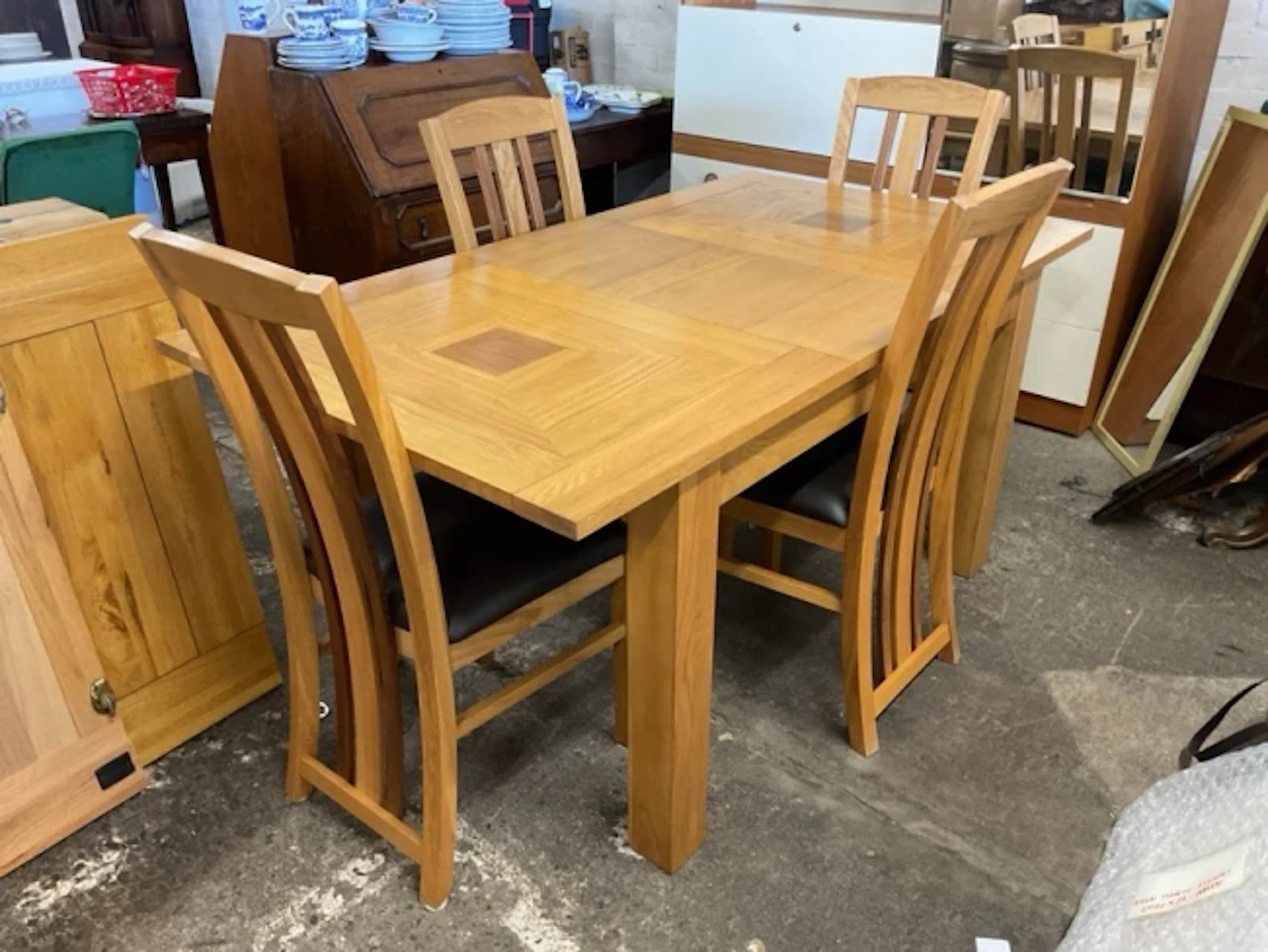 A contemporary oak dining table & chair set, the rectangular table