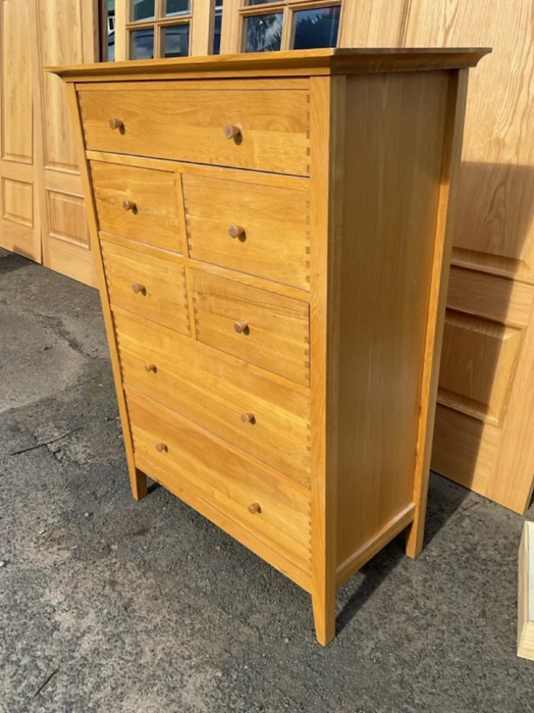 A contemporary Willis & Gambier oak chest of seven drawers with designer