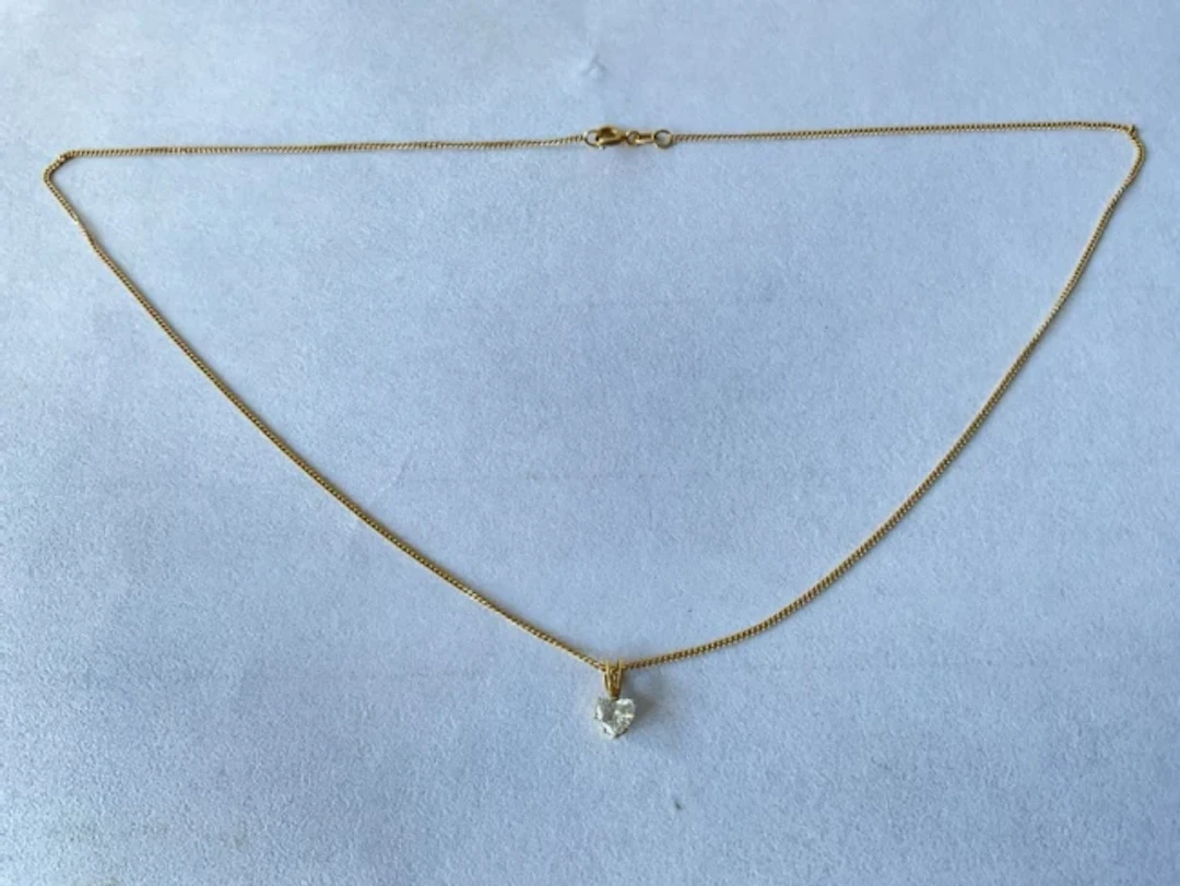 An 18ct gold diamond necklace, the heart shaped stone totalling approximately