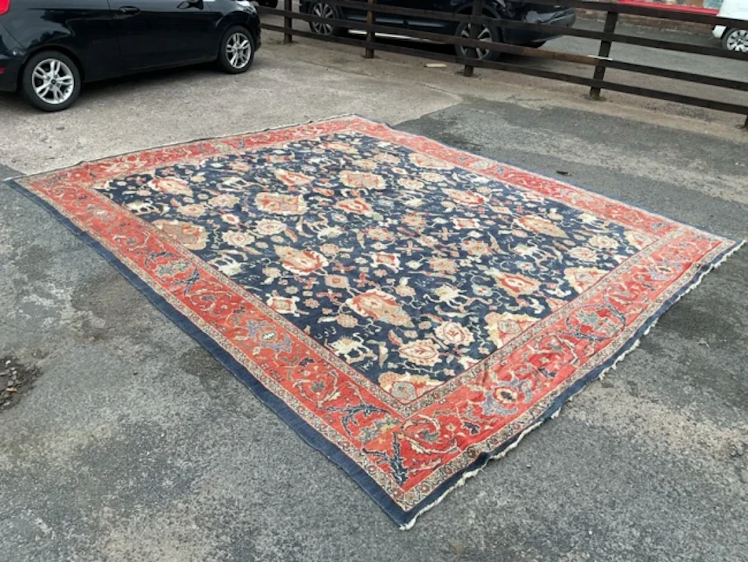 A Tehran wool carpet with multiple Persian lion and sun motifs and