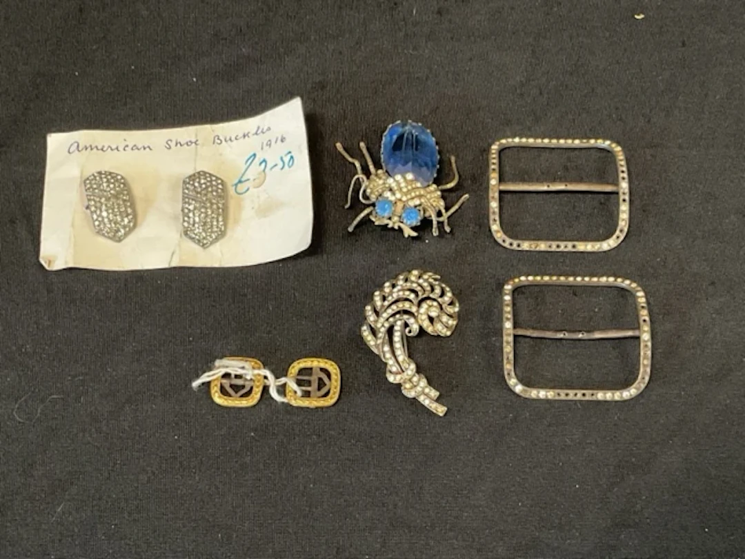 A pair of Georgian gilt brass buckles; diamanté plume brooch; Edwardian