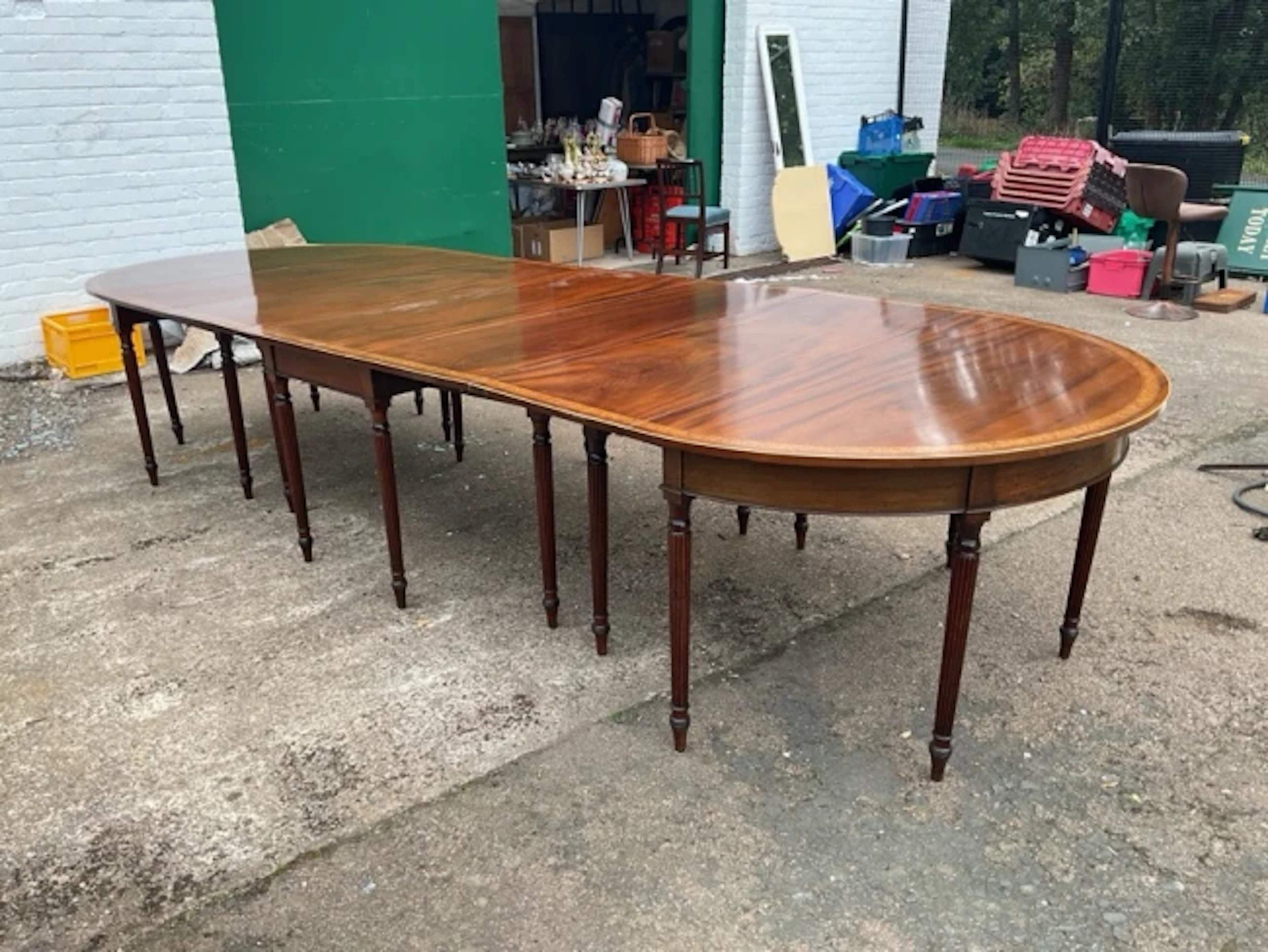 A Georgian mahogany dining table with some alterations - supplied