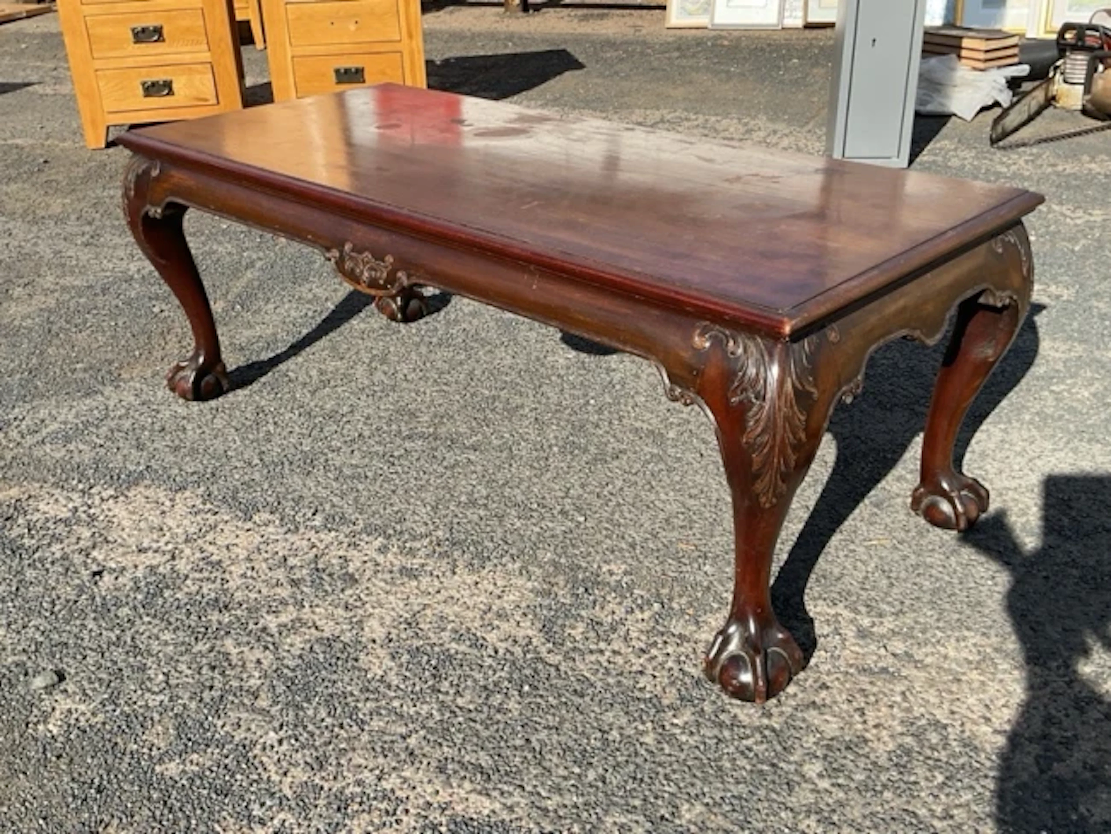 A rectangular mahogany coffee table with moulded top on acanthus scroll