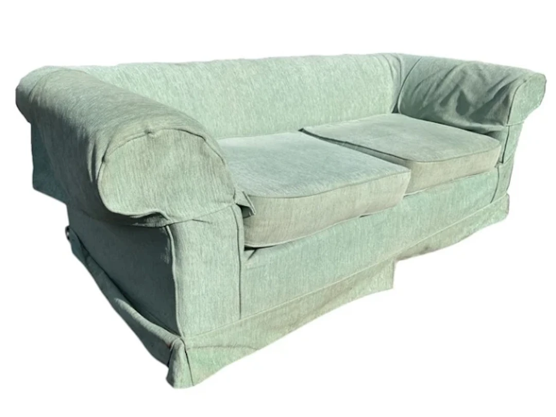 A contemporary country house chesterfield sofa with loose covers