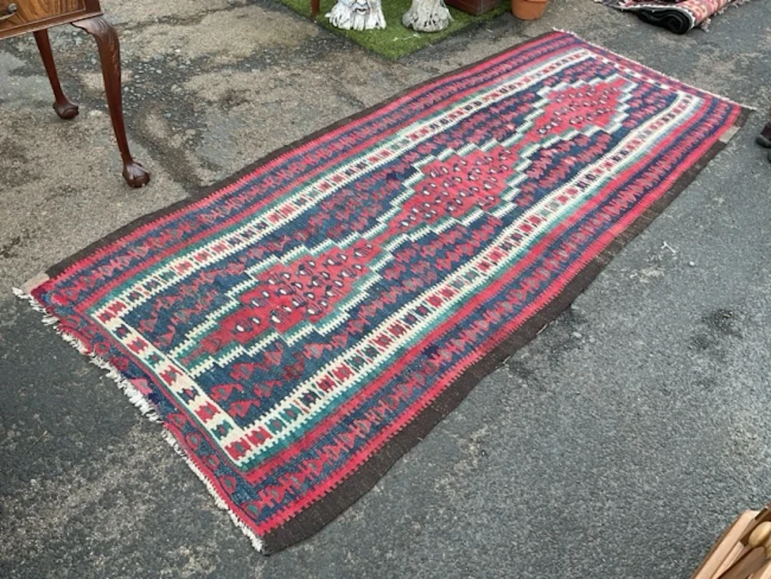 A Harsin flatweave kilim runner with triple conjoined lozenge medallions