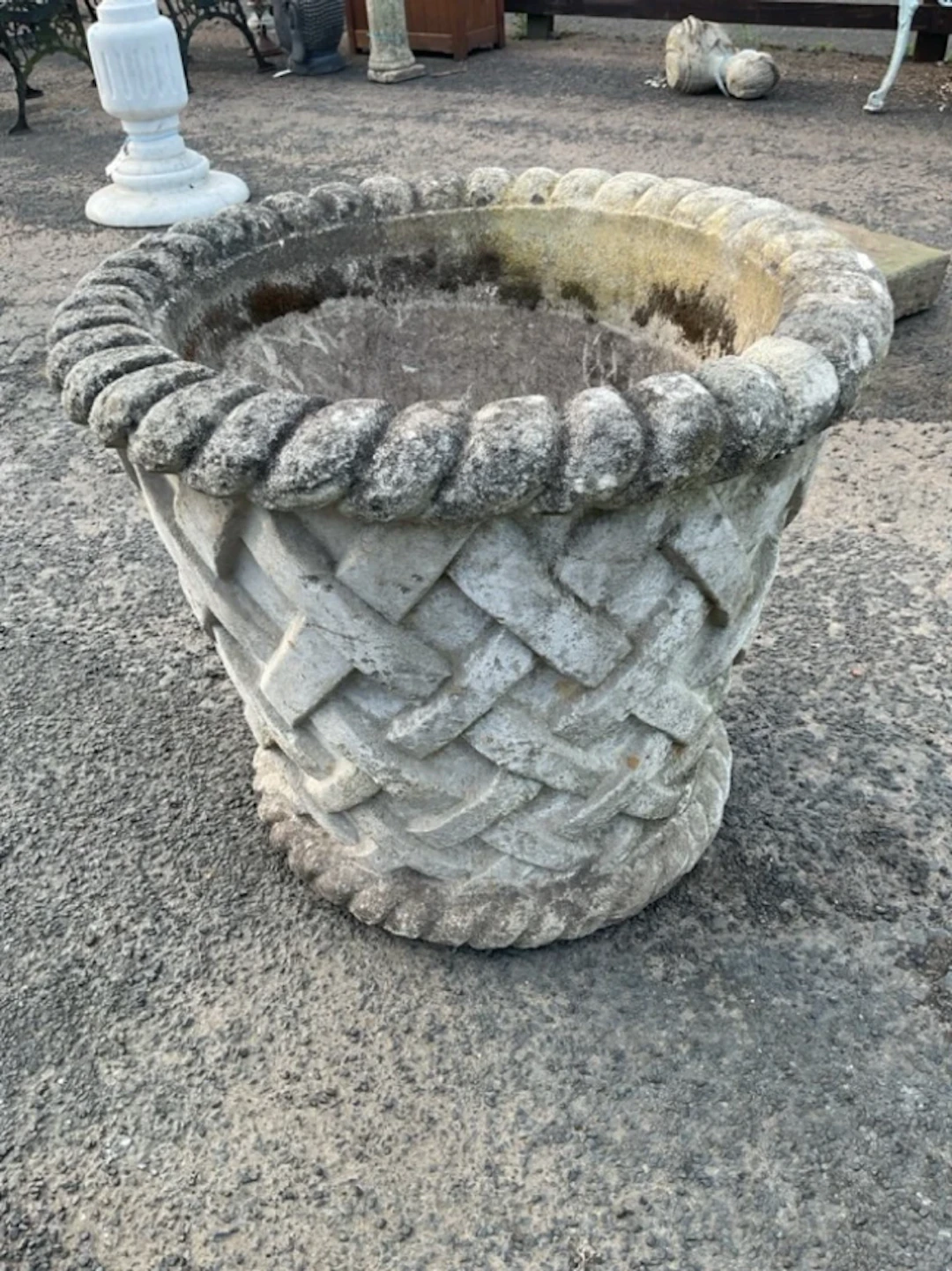A large composition stone tapering garden pot cast with ropetwist