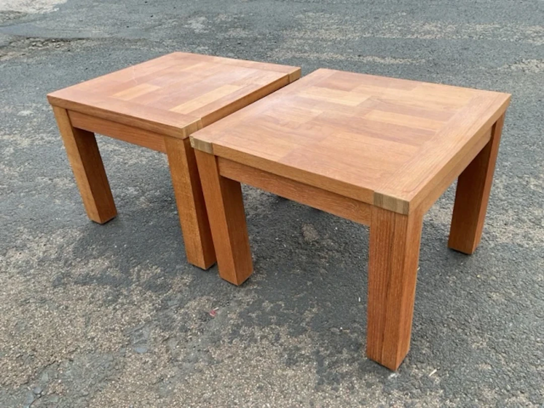 A pair of square teak style coffee tables with parquetry style tops