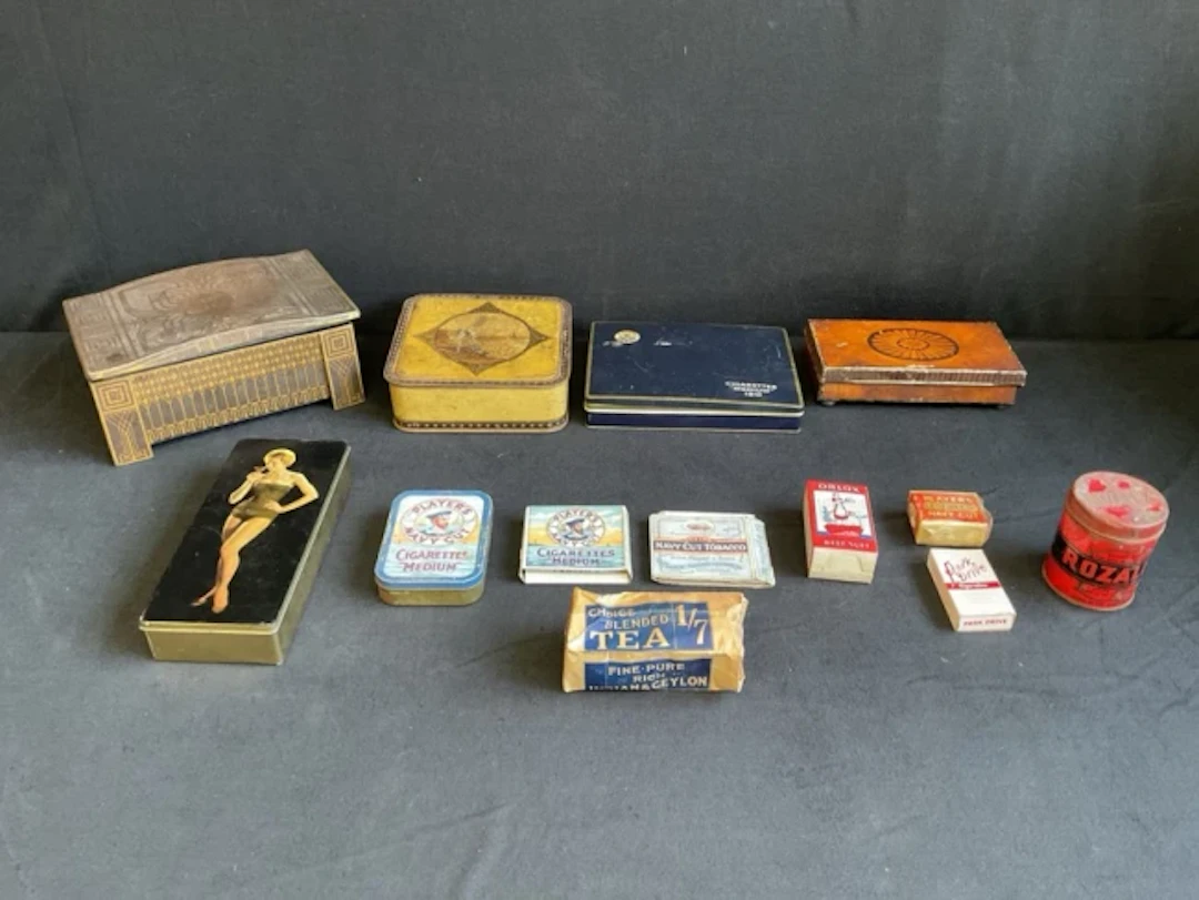 A collection of tins and packaging ephemera - Cadbury and Thorns confectionery.