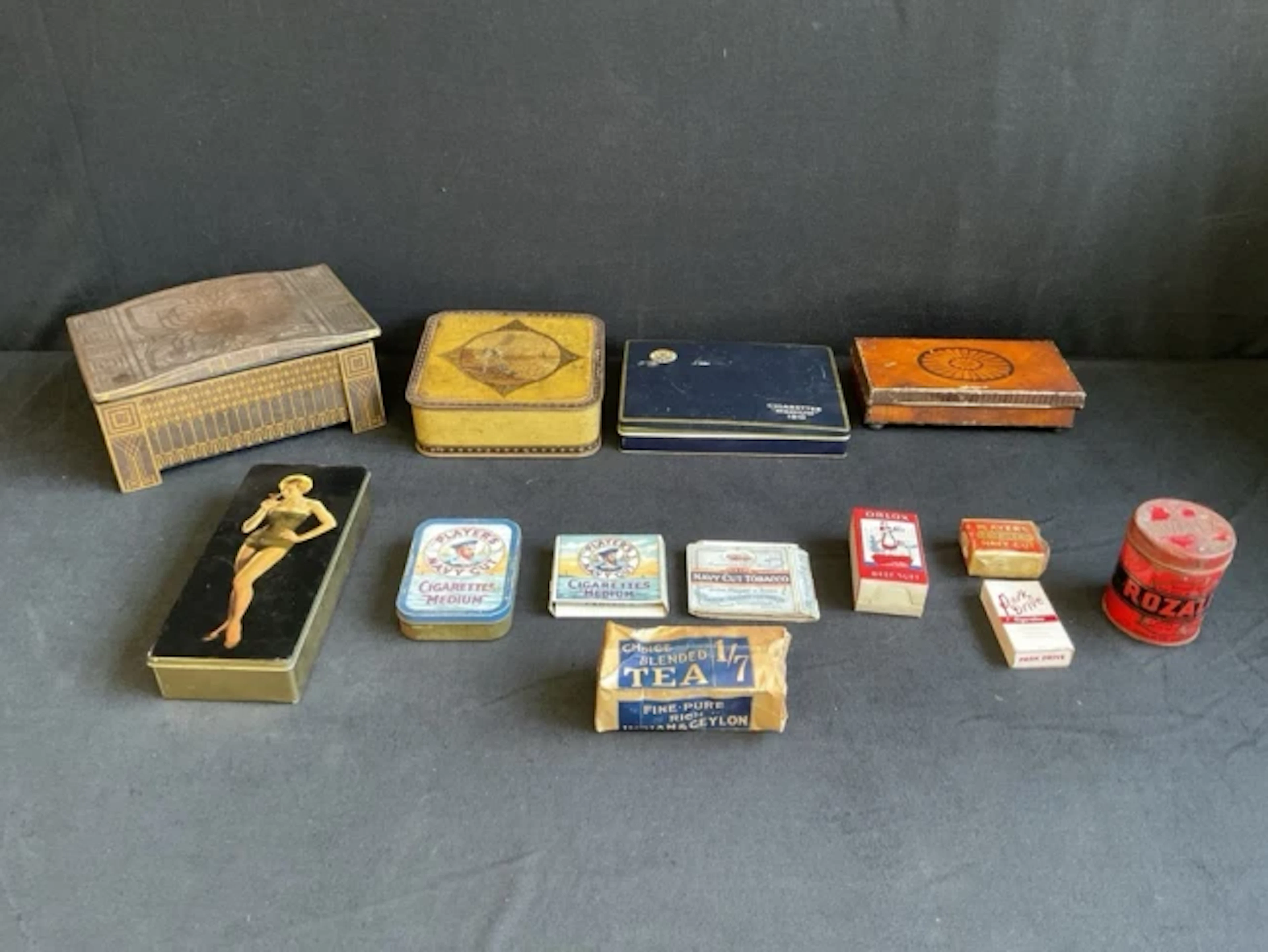 A collection of tins and packaging ephemera - Cadbury and Thorns confectionery.