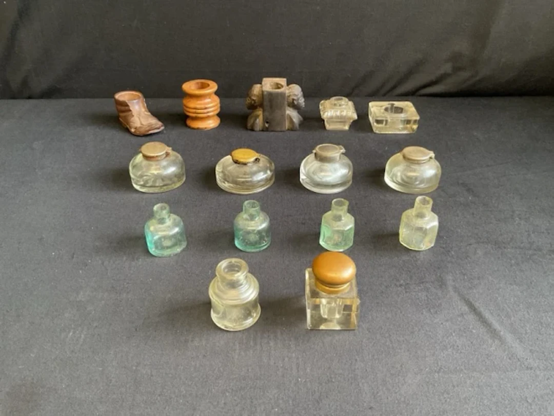 A collection of inkwells and ink bottles - a Black Forest lime wood