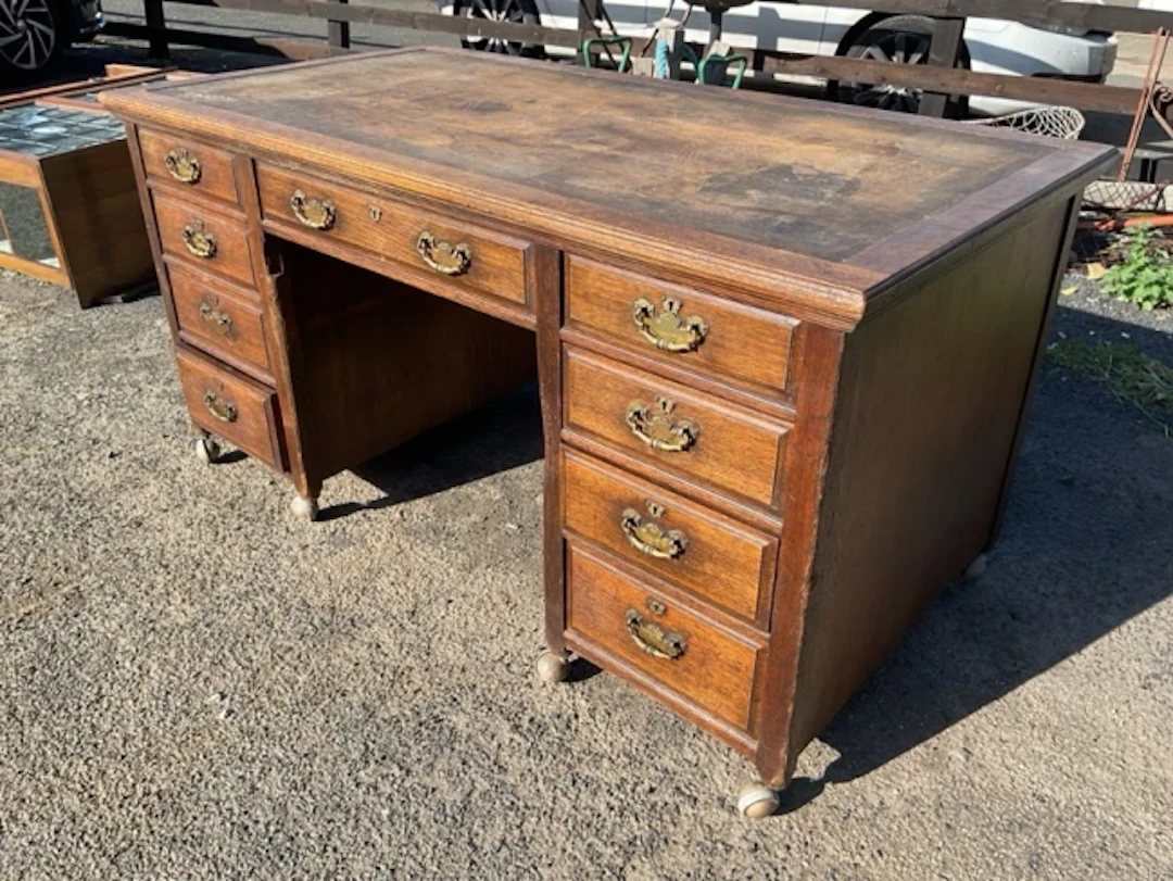 A Victorian oak desk with former leather skiver to rectangular moulded
