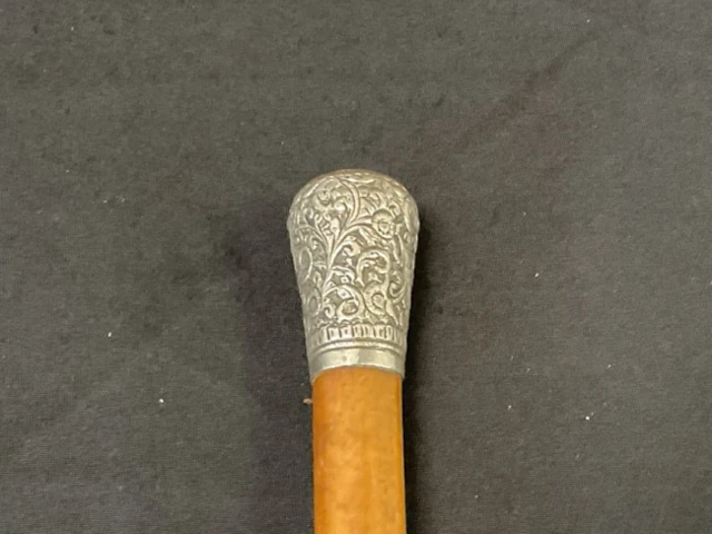 A Victorian malacca cane with white metal knob embossed and chased