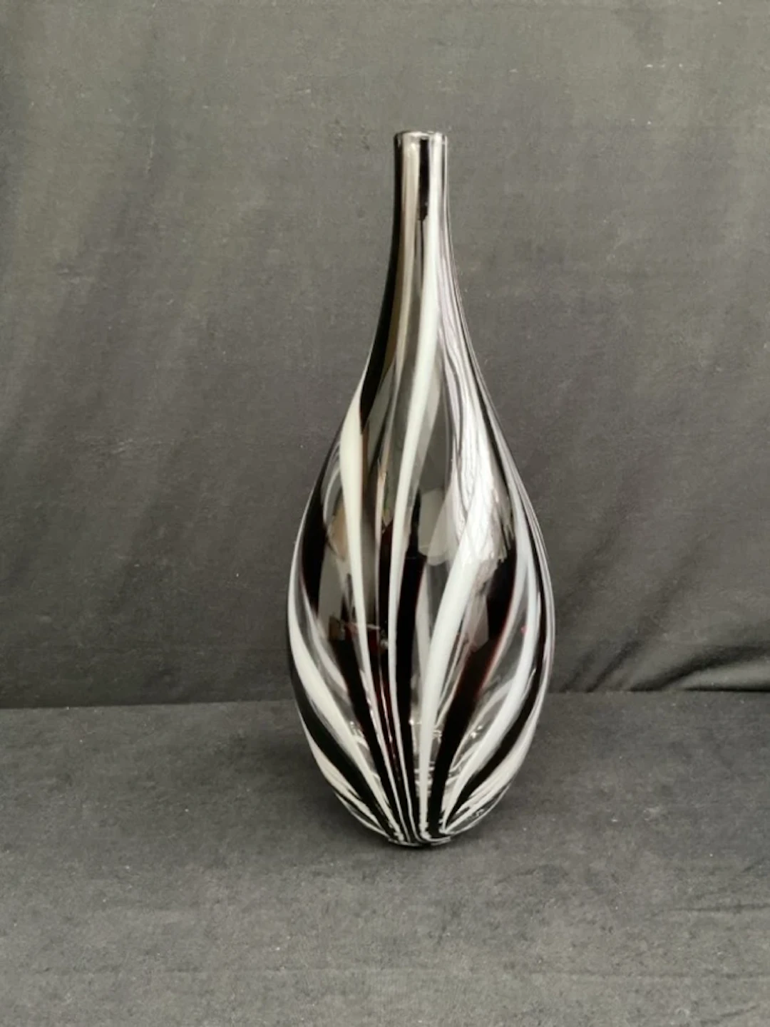 A studio glass bottle vase with brown and white feathered decoration;