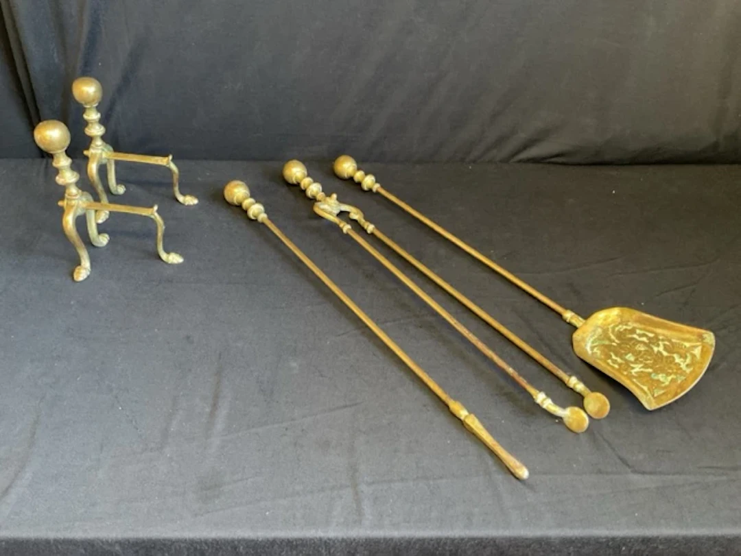 A set of Edwardian brass fire tools with ball finials and turned handle