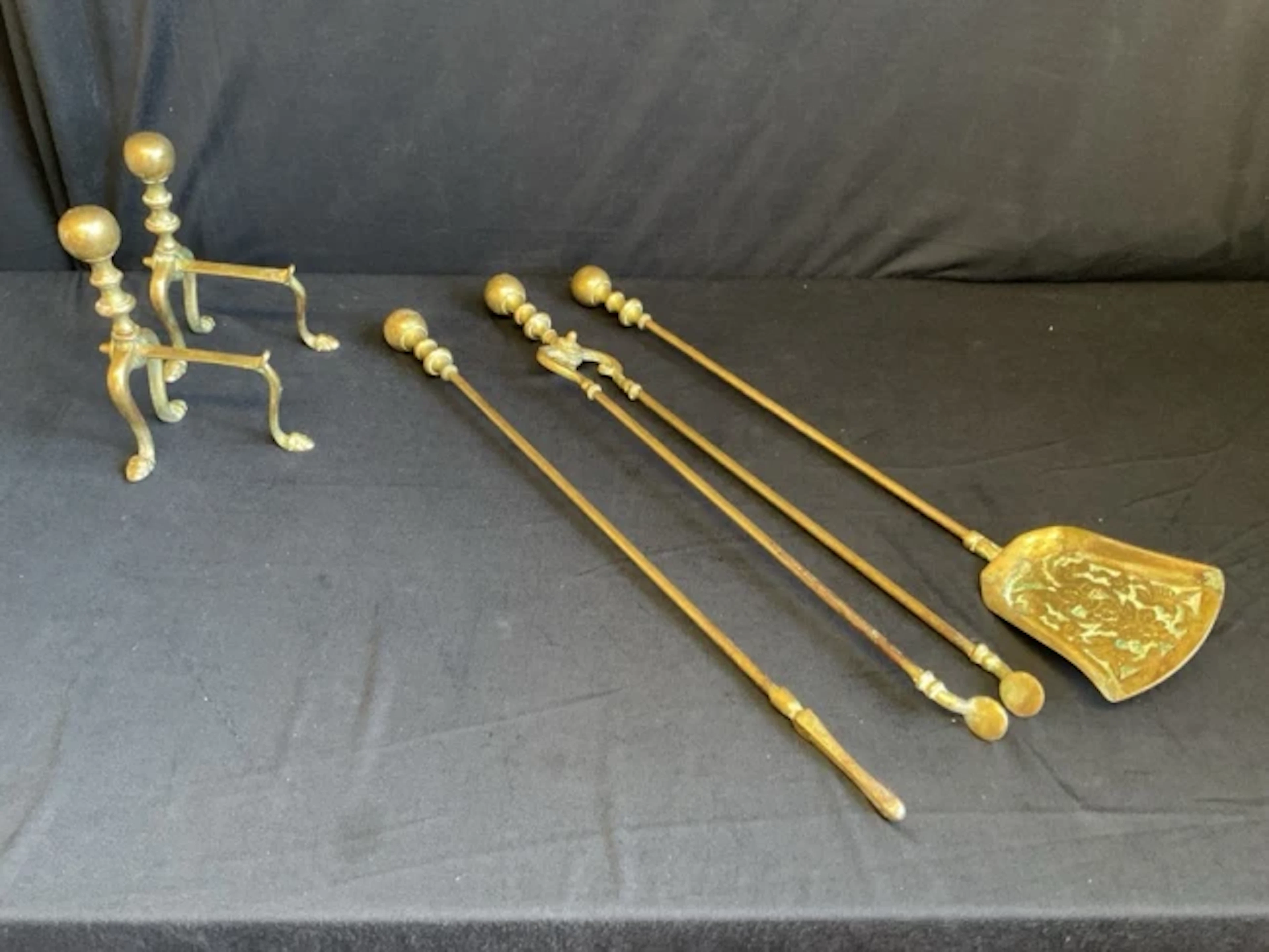 A set of Edwardian brass fire tools with ball finials and turned handle