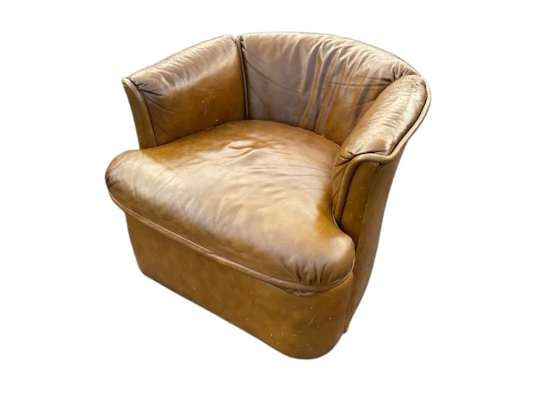 A leather upholstered tub armchair by Drexel, with rounded back and