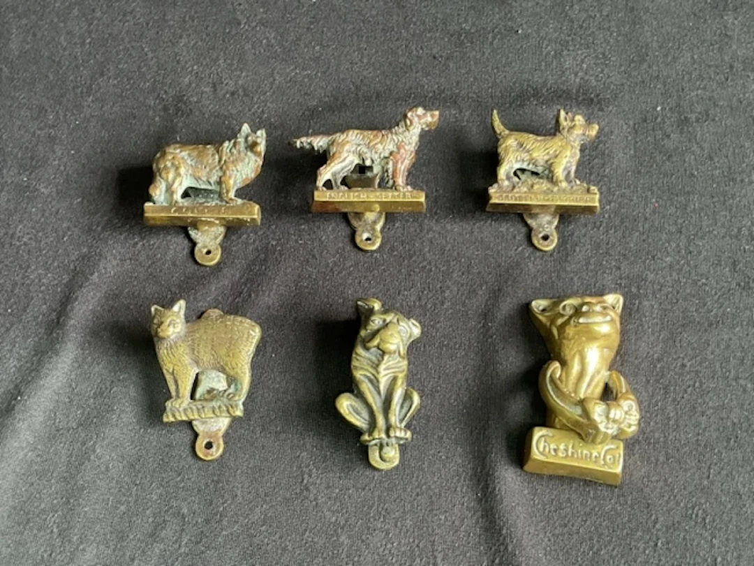 Five miniature brass animal form door knockers including a collie