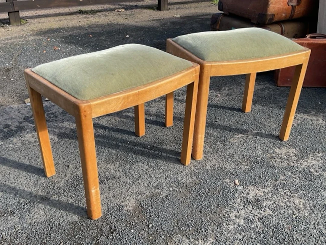A pair of 1950s rectangular stools with dished upholstered seats raised
