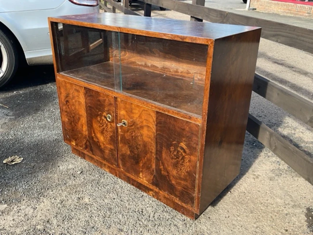 A 60s glazed mahogany cabinet with two sliding glass doors above cupboards