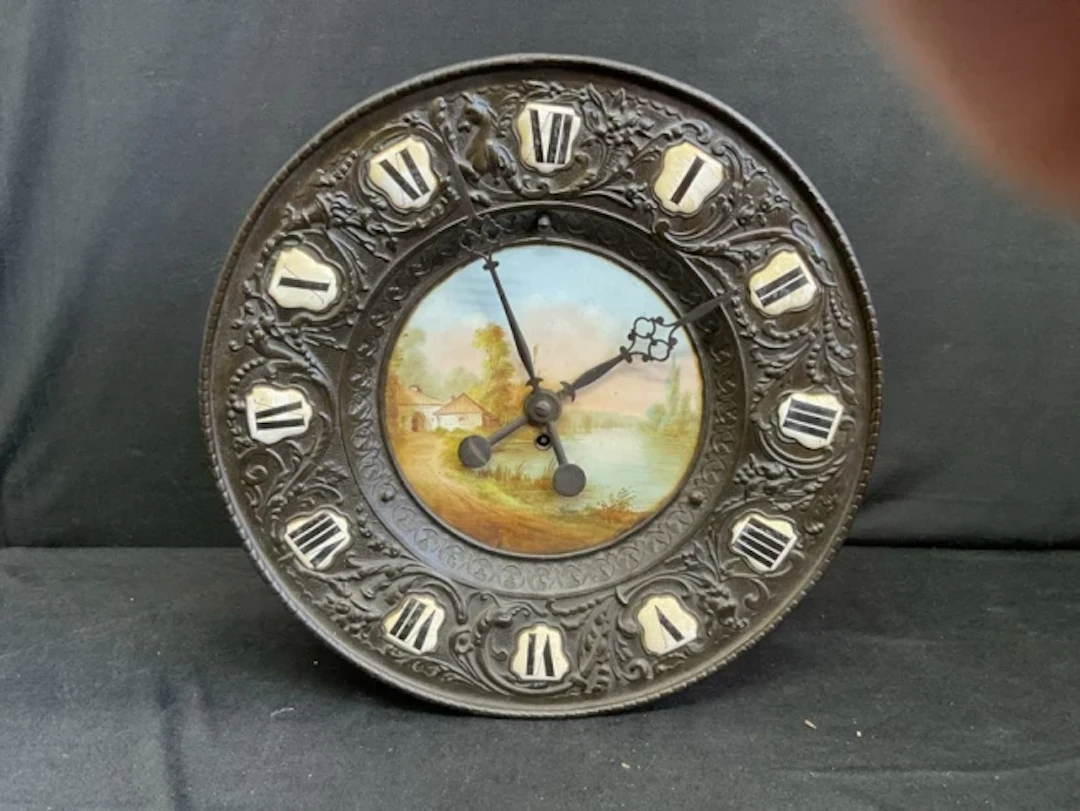 A French charger shaped brass and ceramic wall or mantel clock with