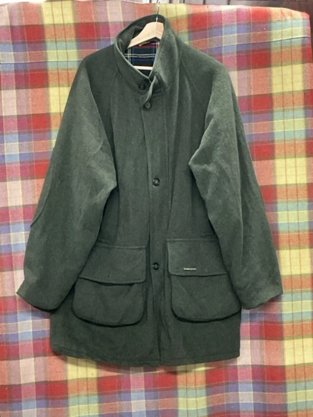 A Hucklecote Loden wool shooting coat with button and zip fastening