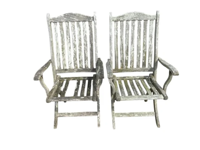 A pair of teak folding garden armchairs with slatted backs & seats