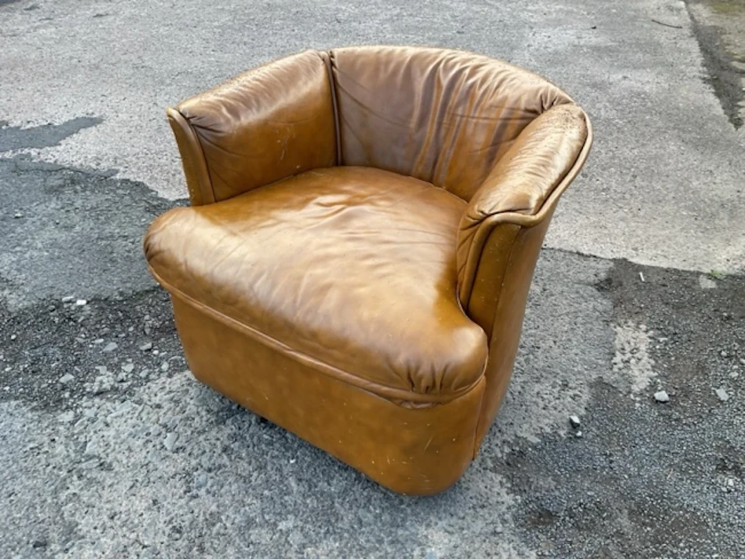 A leather upholstered tub armchair by Drexel with rounded back and