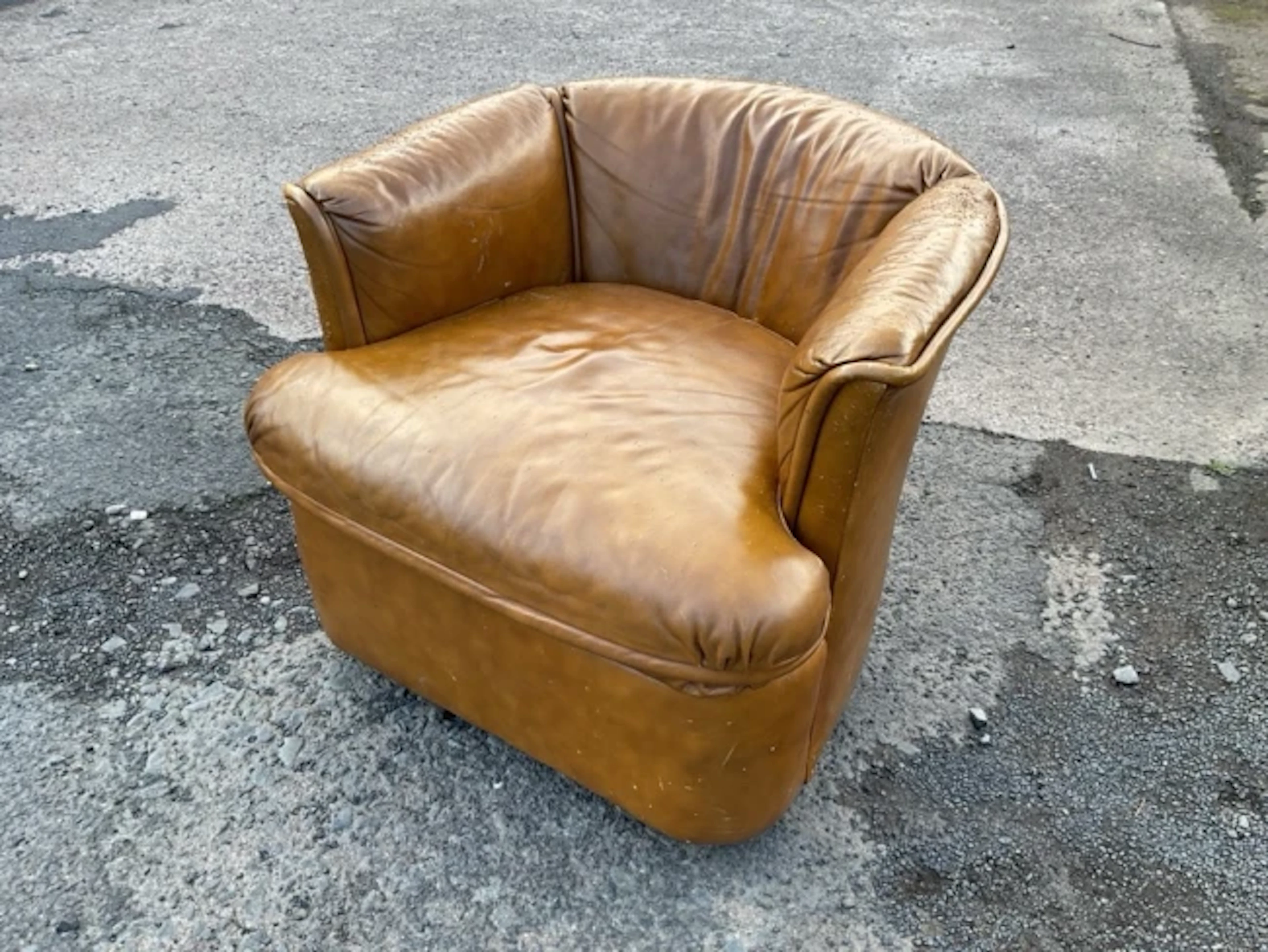 A leather upholstered tub armchair by Drexel with rounded back and