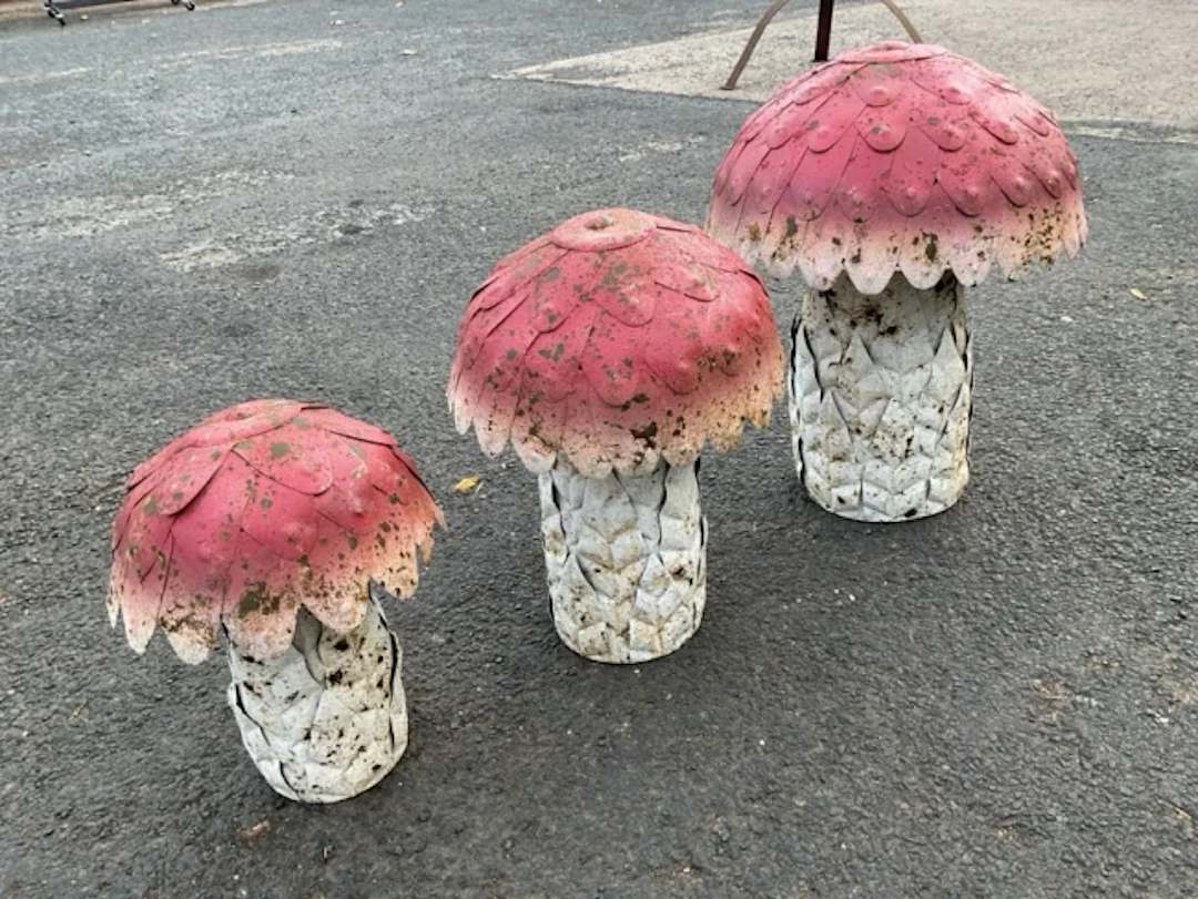 A set of three graduated painted metal garden toadstools. (16.5in - 11in) (3)