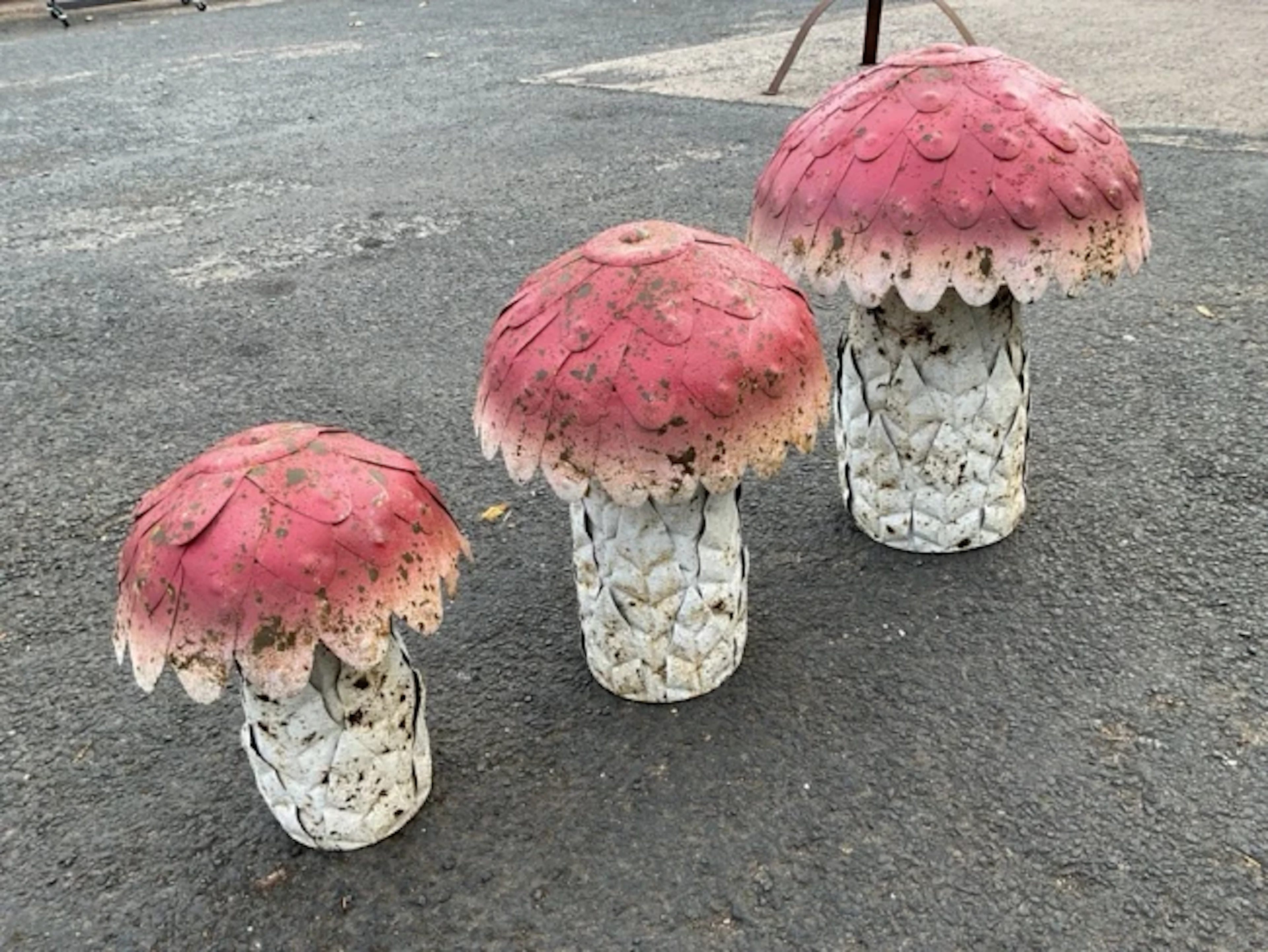 A set of three graduated painted metal garden toadstools. (16.5in - 11in) (3)