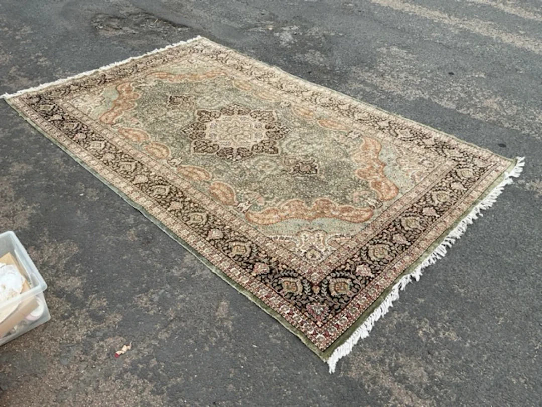A Kashmir silk carpet with petalled medallion amid floral spray motifs