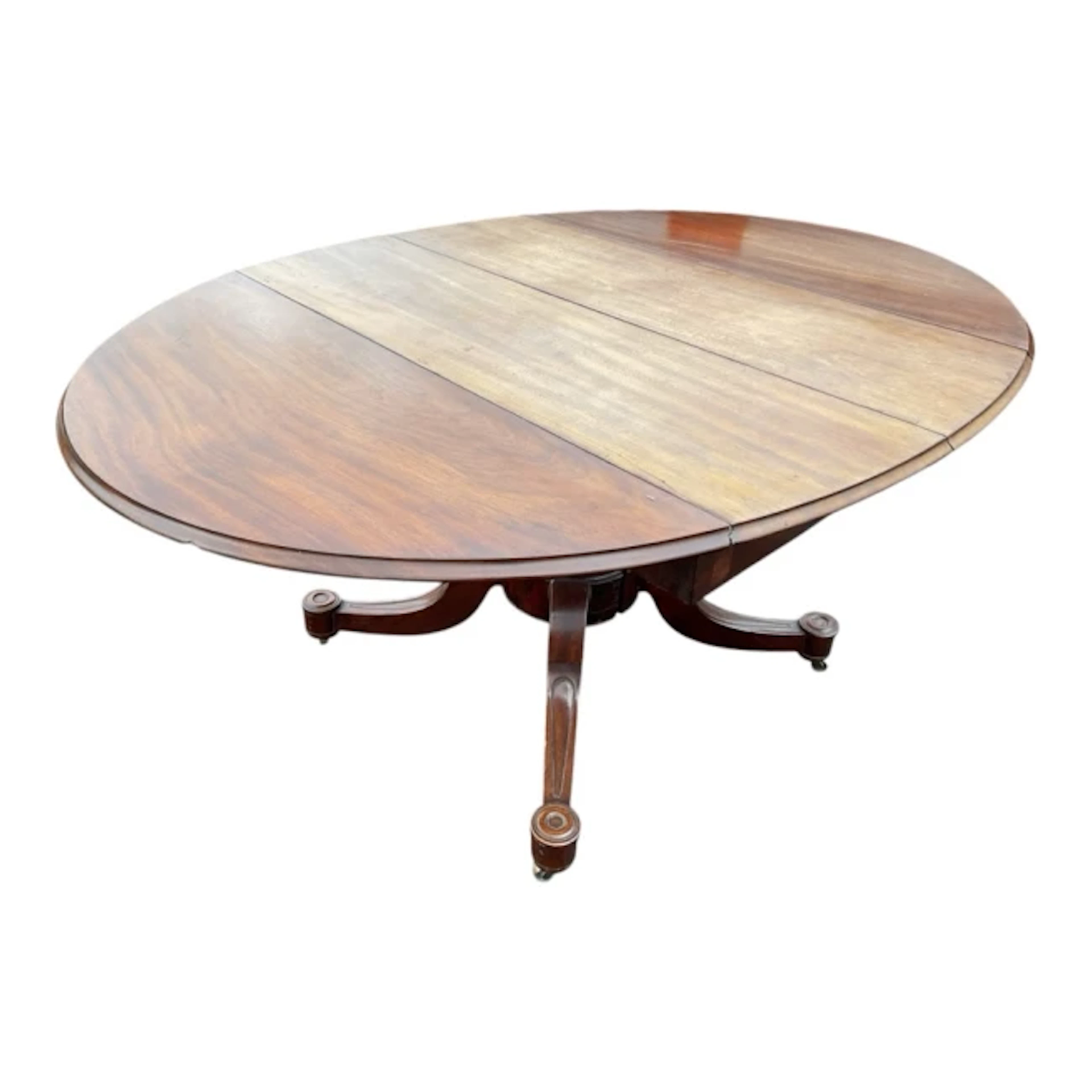 A Victorian oval mahogany extending dining table, the moulded top