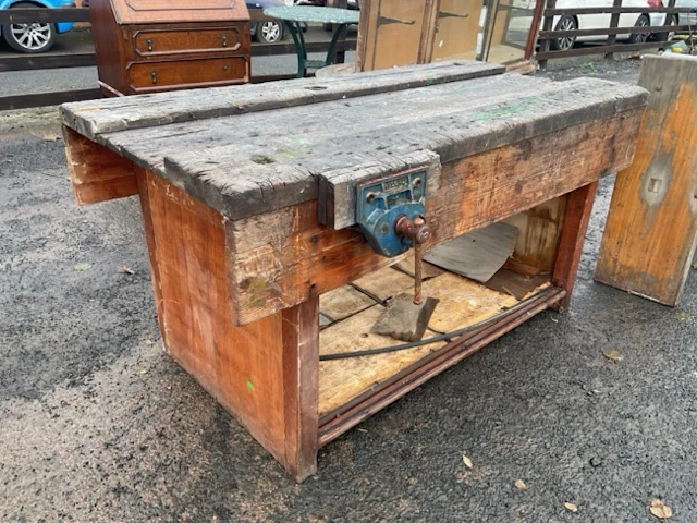 A workbench having channelled rectangular top fitted with two Record