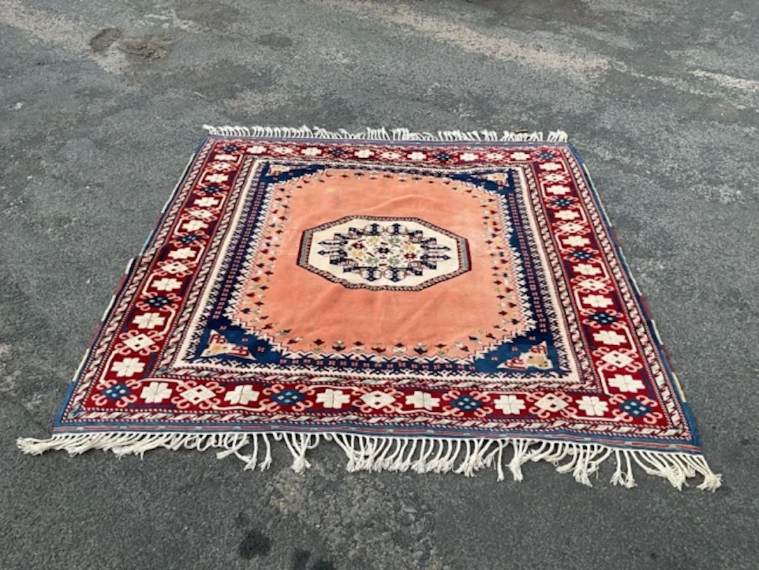 A Turkish wool carpet with octagonal stylised floral medallion on