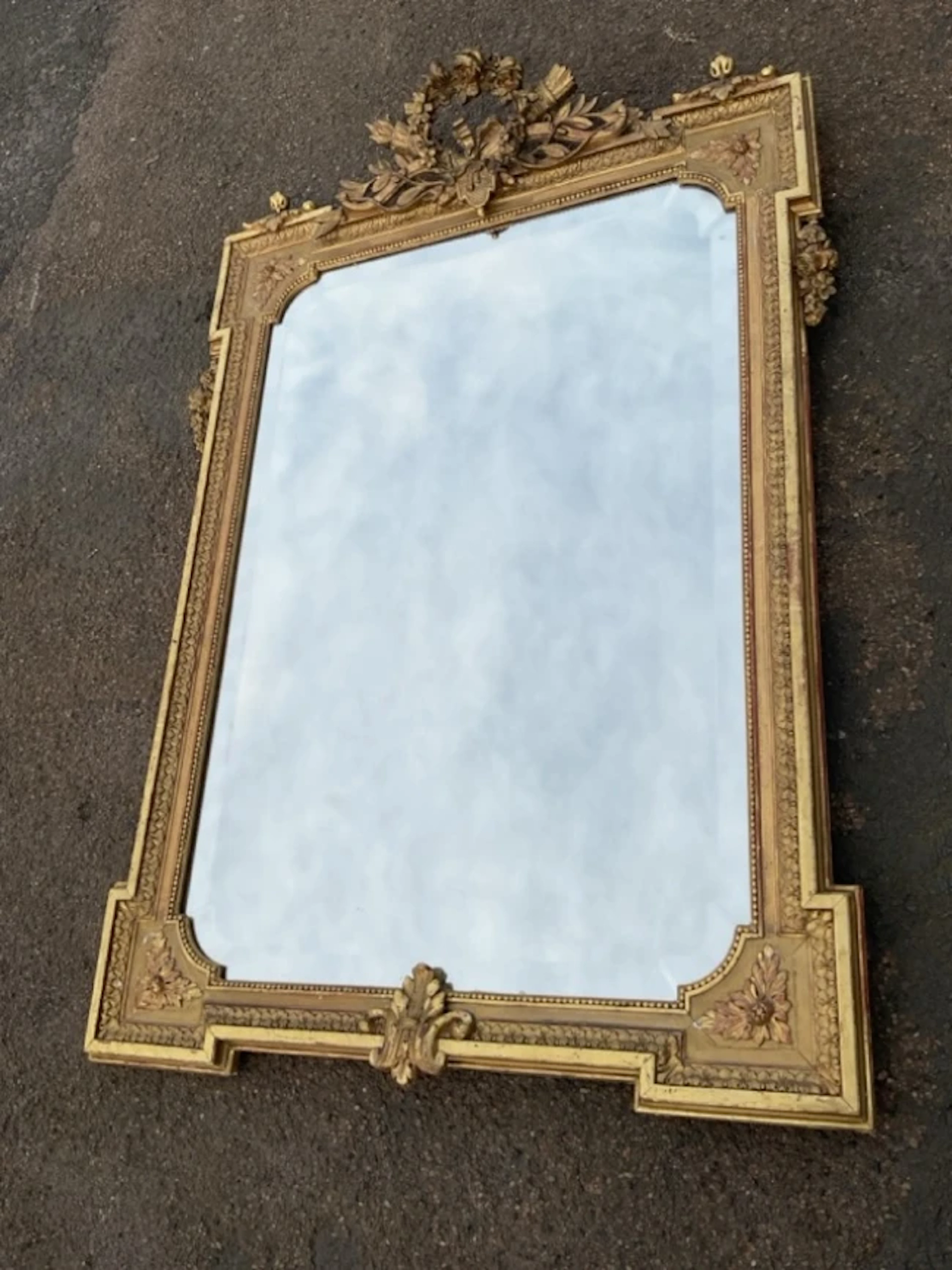 A nineteenth century gilt mirror with fine shaped bevelled plate