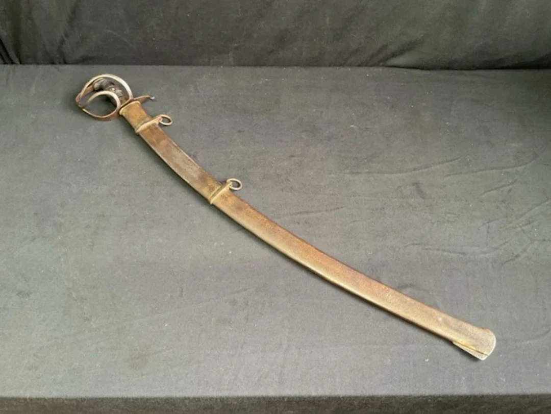 An early C20th other ranks cavalry sabre with three-bar guard, scrolled