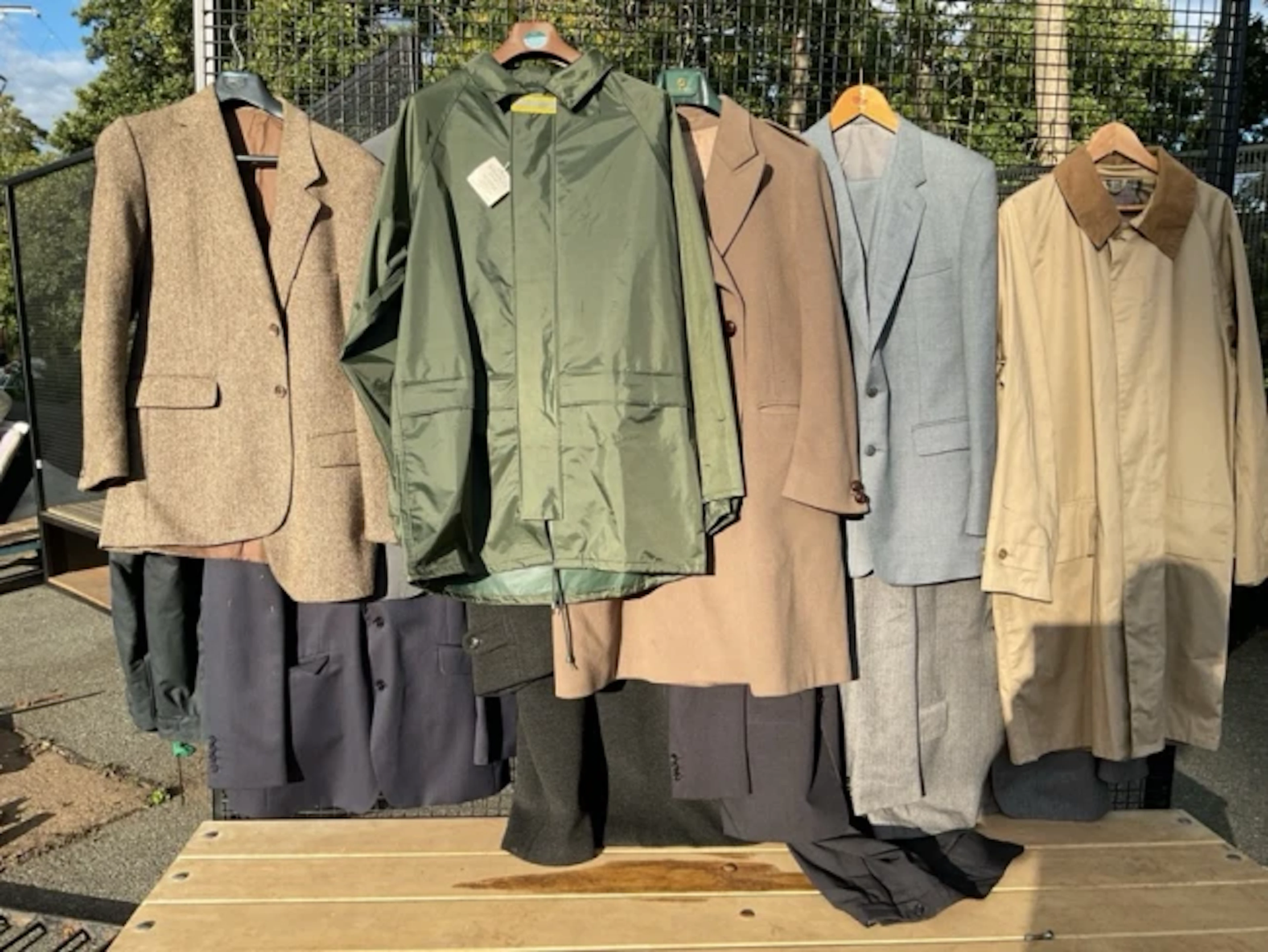 A quantity of gentlemans clothing - coats, suits, jackets, Barbour
