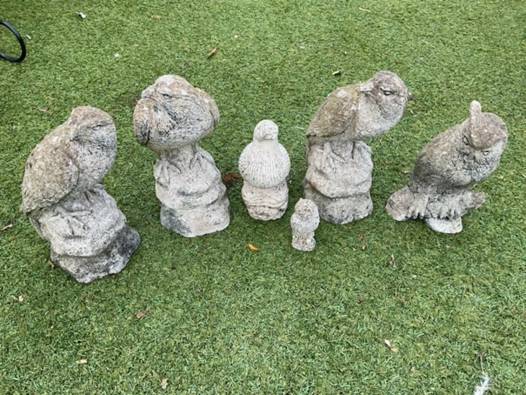 A group of composition stone birds - owls, pigeon, falcon, eagle