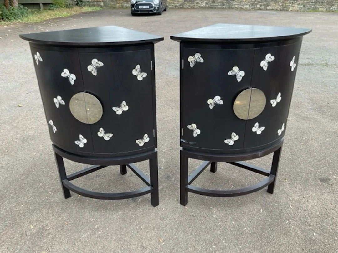 A pair of Todd Merill Studio mahogany bowfronted corner cabinets