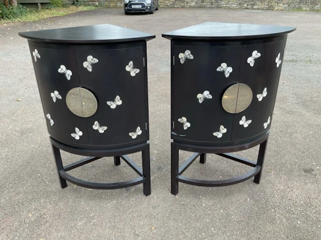 A pair of Todd Merill Studio mahogany bowfronted corner cabinets