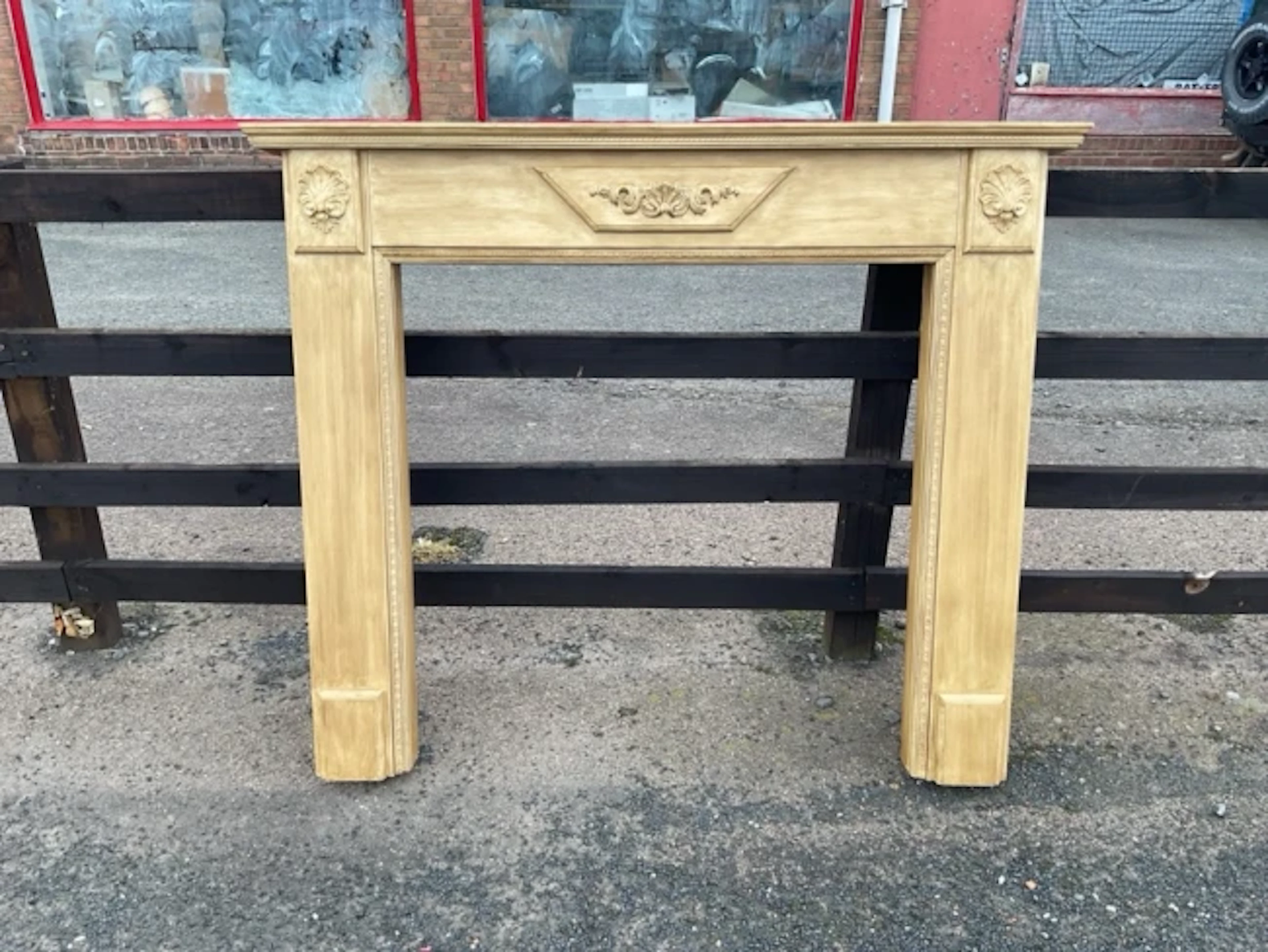 A nineteenth century style chimneypiece with moulded mantleshelf above