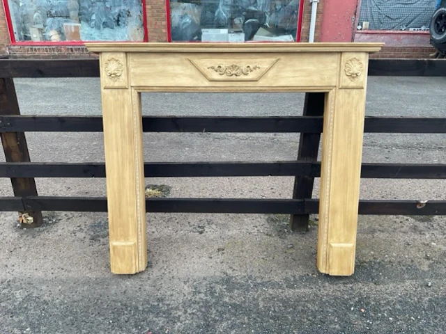 A nineteenth century style chimneypiece with moulded mantleshelf above